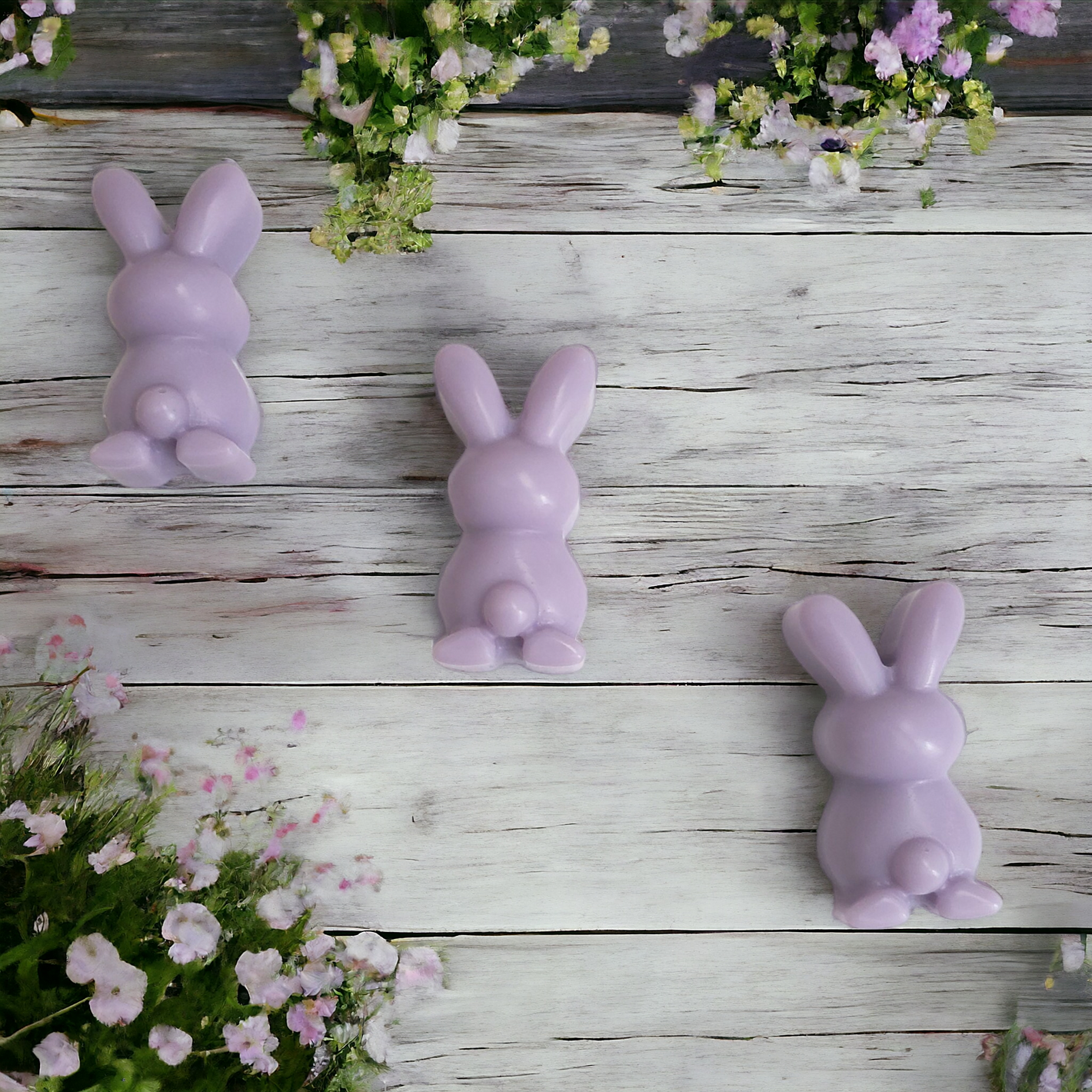 3 purple bunny soy wax melts with purple flowers in the background 