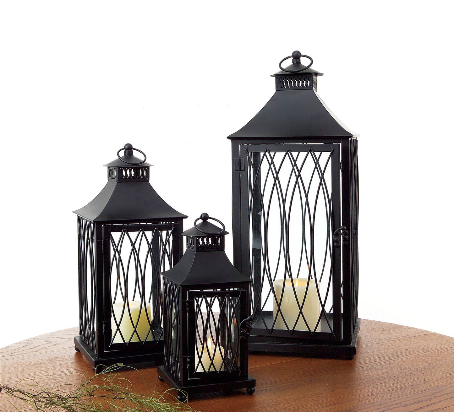 Decorate your living space with this traditional set of decorative lanterns. The classic metal frame paired with a black finish is the perfect combination to make a stunning piece. The sturdy metal composition is sure to last for seasons to come. 
